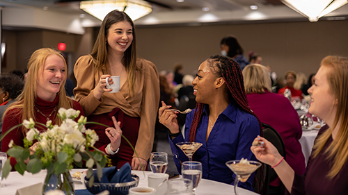 students networking at a dinner